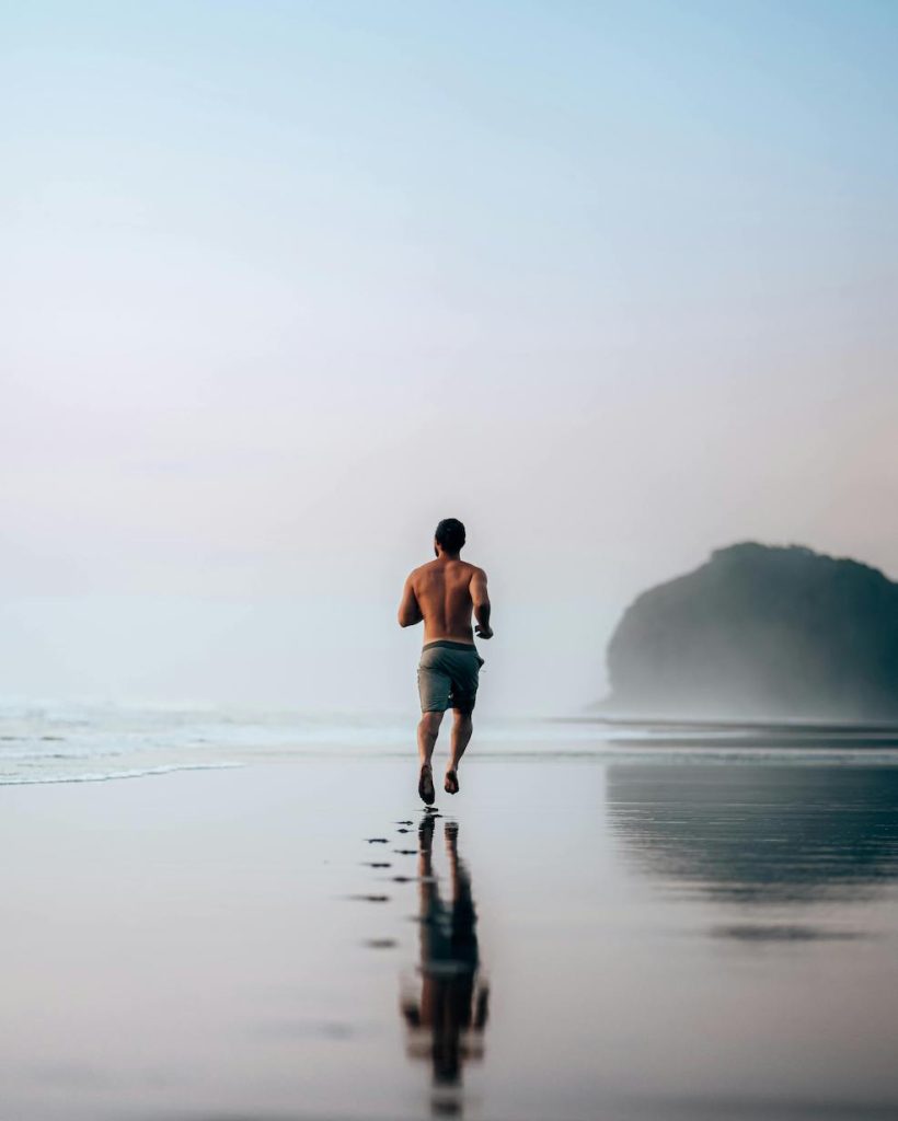 Morning run on the beach at sunrise, in other words a fitness top morning routine